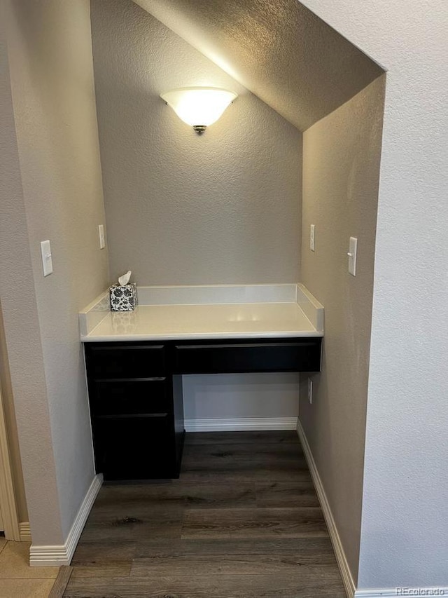 bathroom with wood finished floors and baseboards