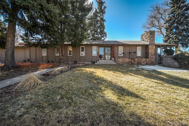 ranch-style home with a garage and a front lawn