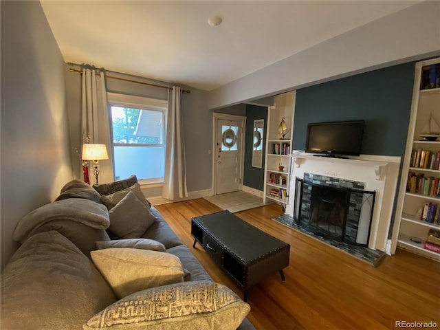 422 E 6th Ave, Denver, CO 80203 - living area with a fireplace, wood finished floors, baseboards, and built in features