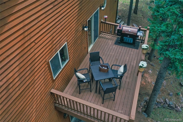 wooden terrace with a grill