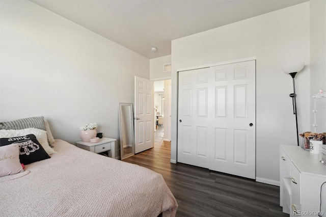 bedroom featuring a closet and dark hardwood / wood-style flooring