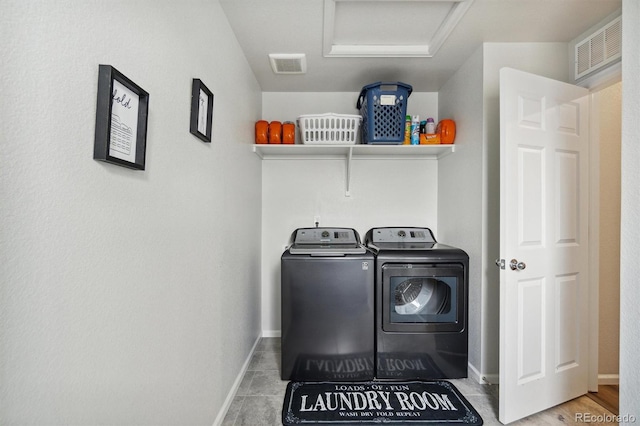 laundry area with tile patterned floors and separate washer and dryer