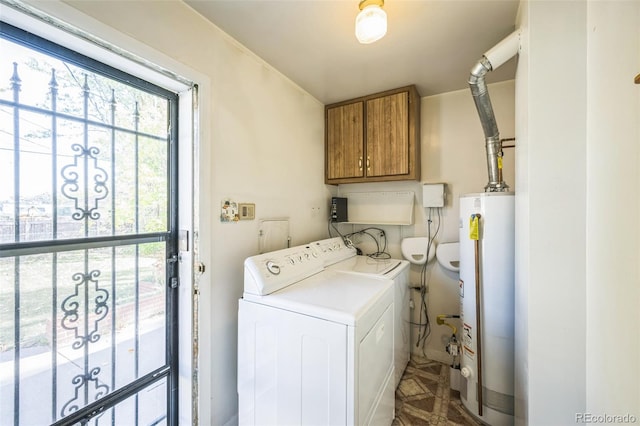 clothes washing area with cabinets, water heater, and washing machine and dryer