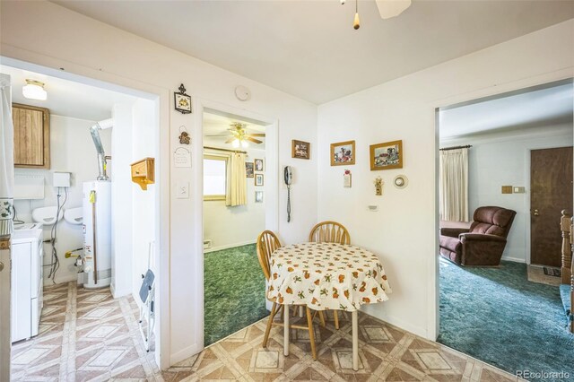 dining space featuring water heater and ceiling fan