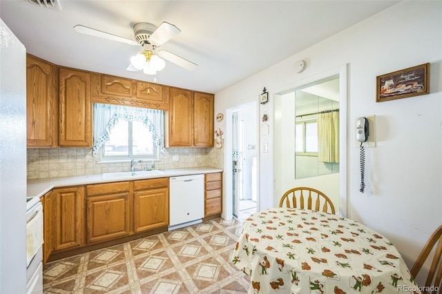 kitchen with decorative backsplash, dishwasher, sink, and ceiling fan