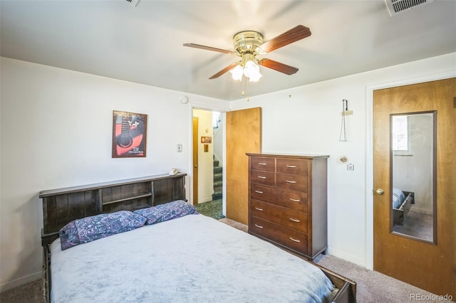 bedroom featuring visible vents, carpet flooring, baseboards, and a ceiling fan