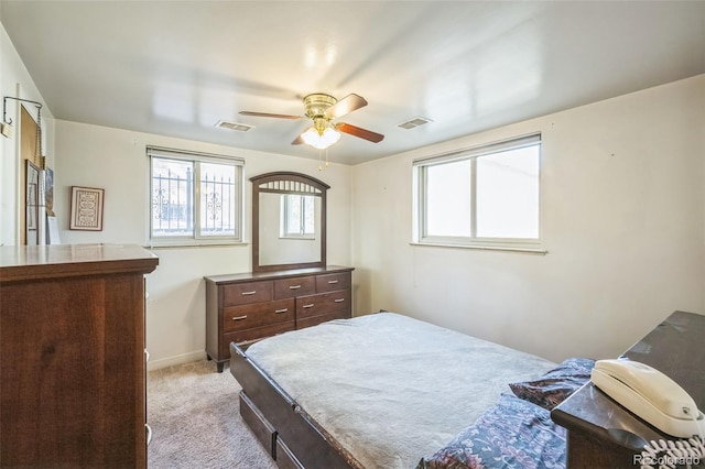 bedroom featuring light colored carpet and ceiling fan