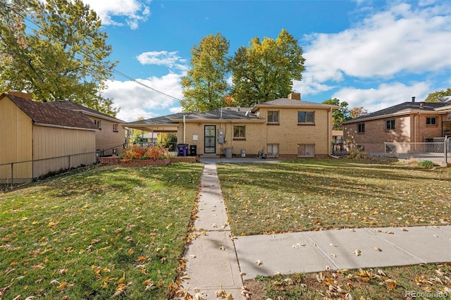 rear view of property featuring a yard