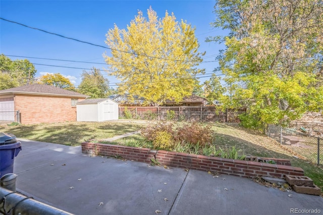 view of patio with an outdoor structure, a fenced backyard, and a shed
