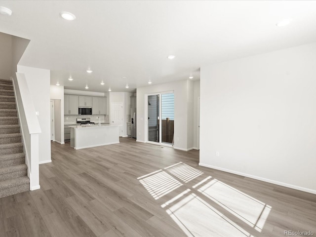 unfurnished living room featuring wood-type flooring