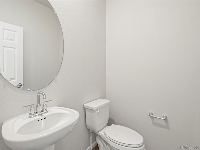 bathroom with toilet and sink