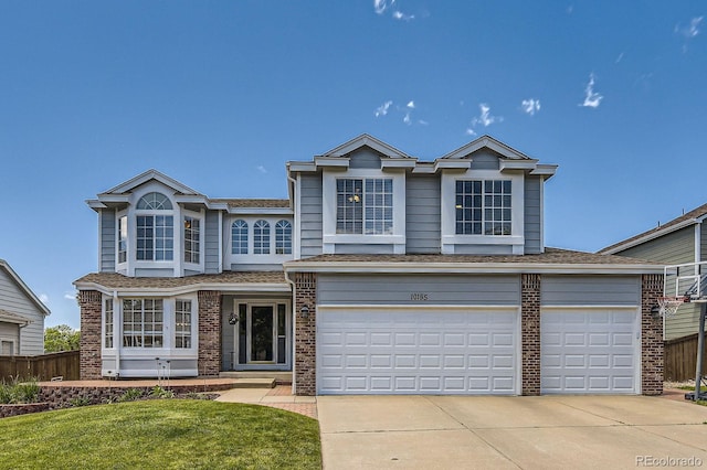 10155 Silver Maple Cir, Highlands Ranch, CO 80129 - view of front of property with brick siding, concrete driveway, a garage, and a shingled roof