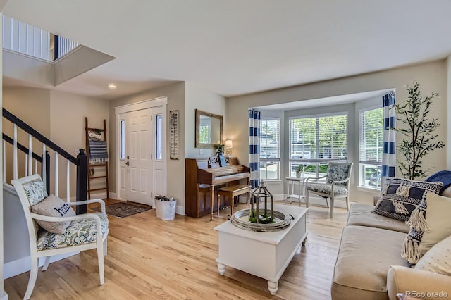 10155 Silver Maple Cir, Highlands Ranch, CO 80129 - living area featuring light wood finished floors, baseboards, and stairs