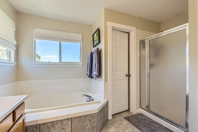 10155 Silver Maple Cir, Highlands Ranch, CO 80129 - bathroom featuring a stall shower, a garden tub, vanity, and tile patterned floors