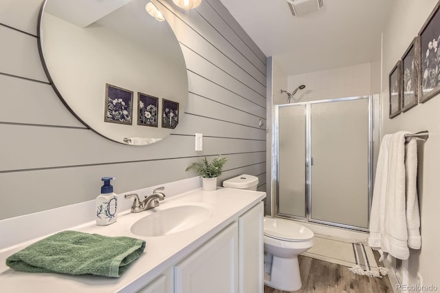 10155 Silver Maple Cir, Highlands Ranch, CO 80129 - bathroom featuring an enclosed shower, vanity, toilet, wood finished floors, and wood walls