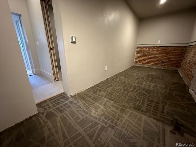 26 E Jewell Ave, Denver, CO 80210 - unfurnished room with brick wall