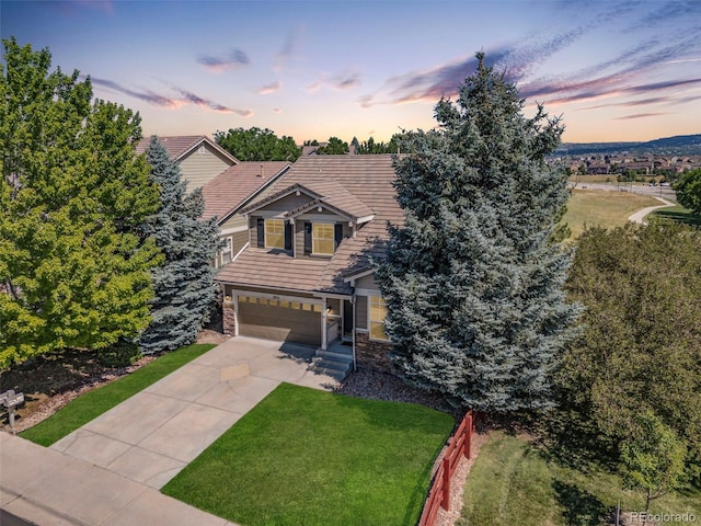 view of front of house with a garage and a yard