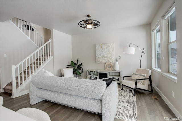 living room with ceiling fan, plenty of natural light, and hardwood / wood-style flooring