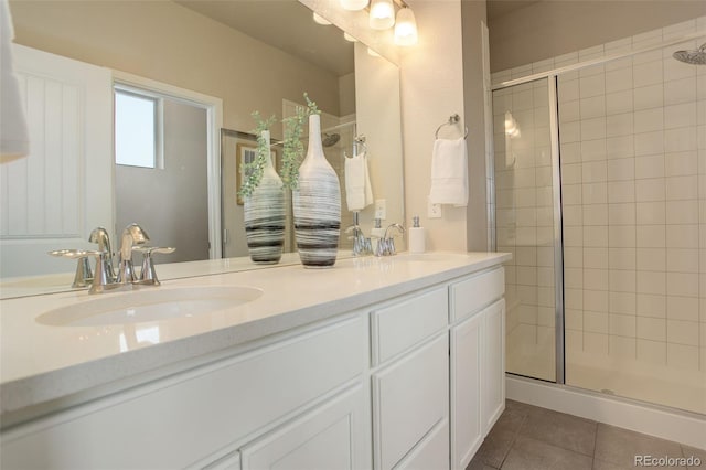 bathroom featuring a shower with door, vanity, and tile patterned flooring