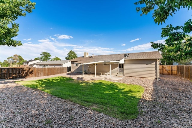 3082 S Laredo Cir, Aurora, CO 80013 - back of property featuring a patio, a fenced backyard, and a chimney