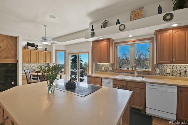 6240 Wilson Rd, Colorado Springs, CO 80919 - kitchen with dishwasher, black electric cooktop, a sink, tasteful backsplash, and a ceiling fan