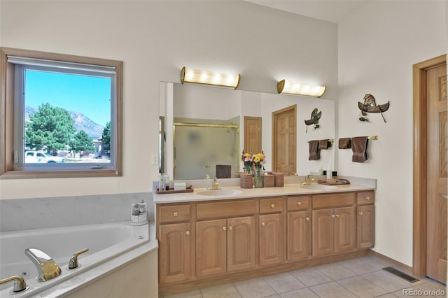 6240 Wilson Rd, Colorado Springs, CO 80919 - bathroom with a shower stall, double vanity, a jetted tub, and tile patterned flooring