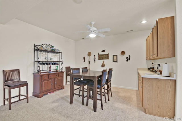 6240 Wilson Rd, Colorado Springs, CO 80919 - dining area featuring light carpet, a ceiling fan, and baseboards