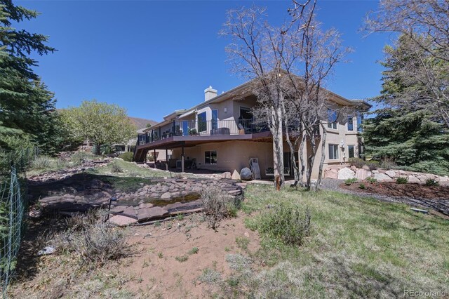 6240 Wilson Rd, Colorado Springs, CO 80919 - back of house featuring a chimney and a deck