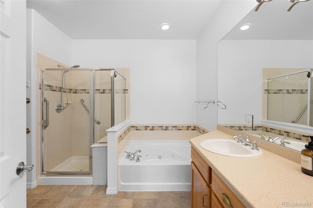 6658 S Shawnee Ct, Aurora, CO 80016 - full bath featuring a jetted tub, vanity, a shower stall, and recessed lighting