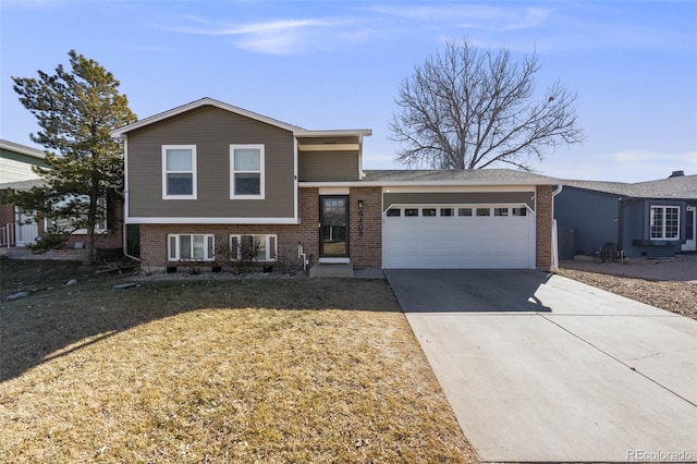 tri-level home with a garage and a front yard