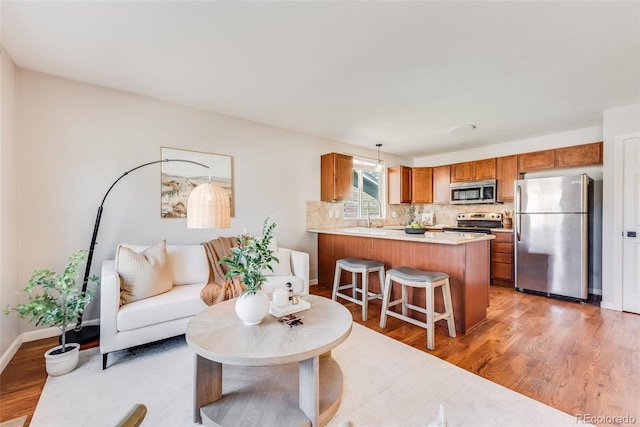 living room with hardwood / wood-style floors and sink