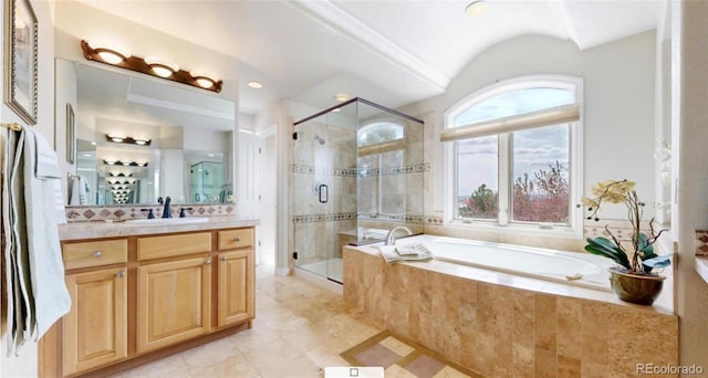 bathroom featuring vanity, a stall shower, and a garden tub
