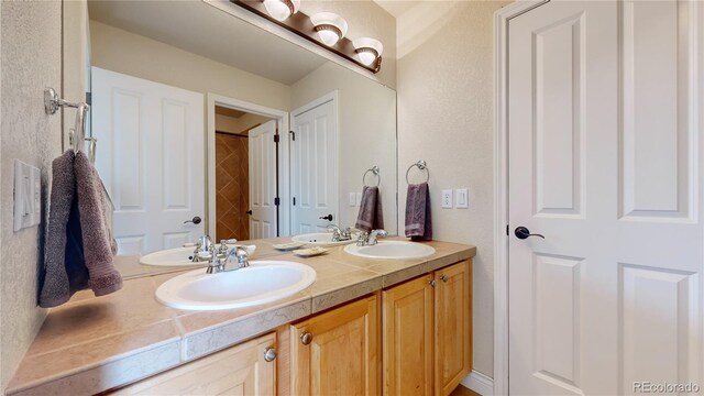 bathroom featuring double vanity and a sink