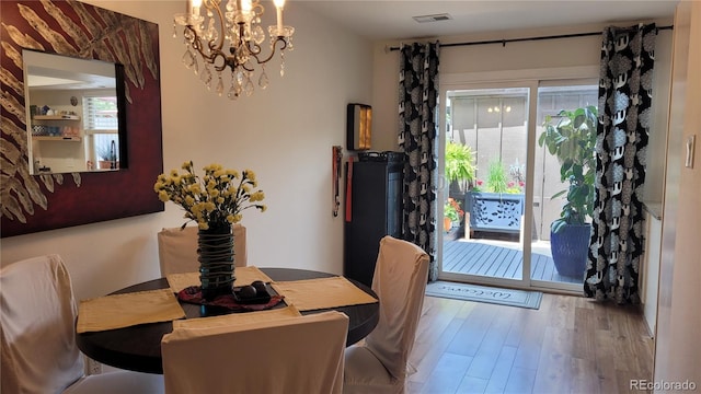 442 S Carr St, Lakewood, CO 80226 - dining area with a chandelier and wood finished floors