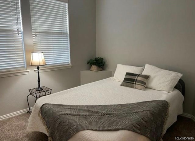 bedroom featuring baseboards and carpet floors