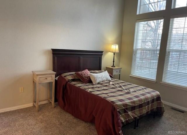 carpeted bedroom with visible vents and baseboards