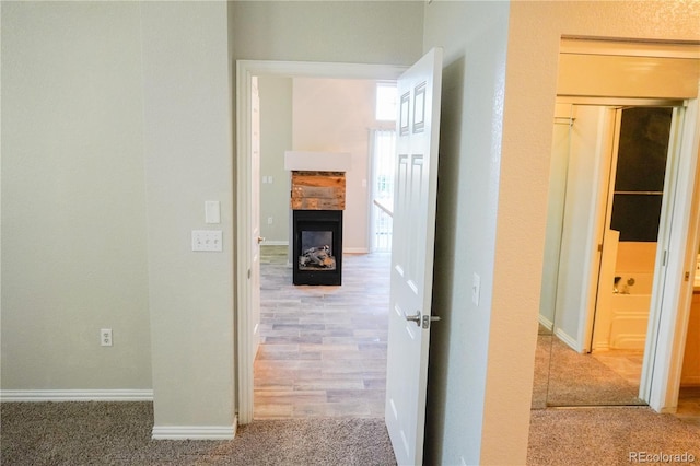 hall with carpet flooring and baseboards
