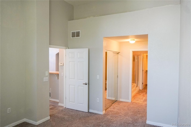 unfurnished bedroom with visible vents, baseboards, and carpet