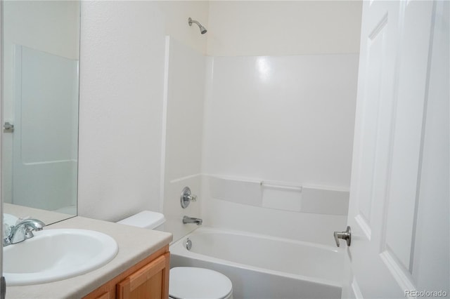 bathroom featuring toilet, vanity, and  shower combination
