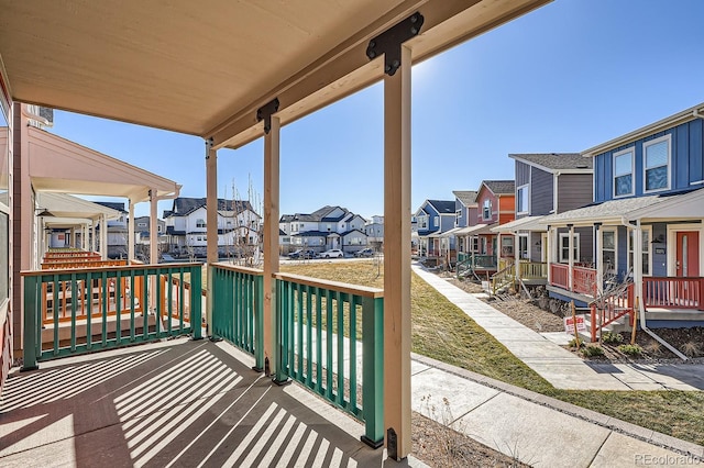 wooden terrace featuring a porch and a residential view