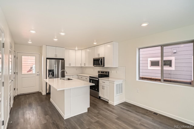 kitchen featuring backsplash, light countertops, stainless steel appliances, dark wood-style floors, and white cabinetry