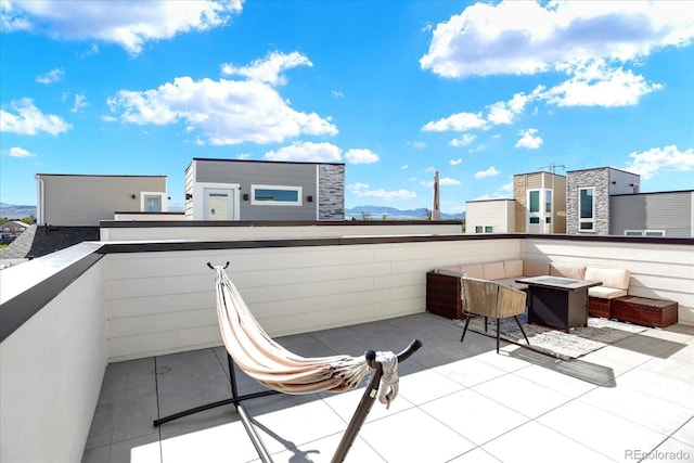 11205 W 53rd Ln, Arvada, CO 80002 - view of patio / terrace with an outdoor fire pit, a balcony, and a mountain view