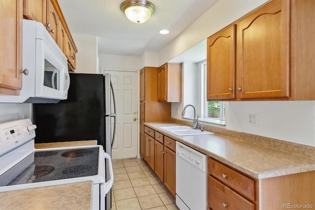 kitchen with sink, white appliances, and light tile patterned floors