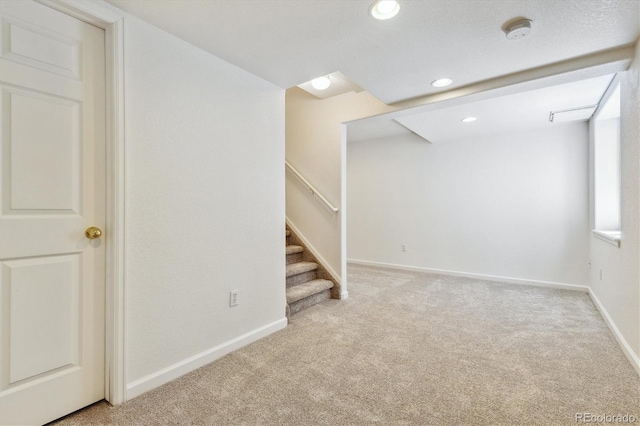 basement featuring light carpet