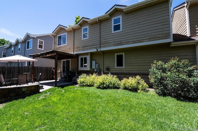 rear view of house with a patio, a lawn, and a pergola