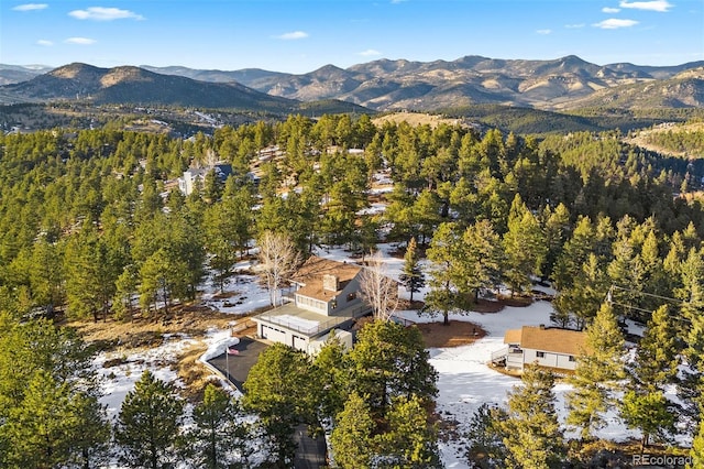 bird's eye view featuring a forest view and a mountain view