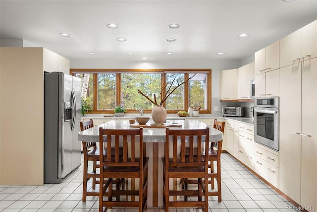 interior space featuring recessed lighting, a toaster, and light tile patterned flooring