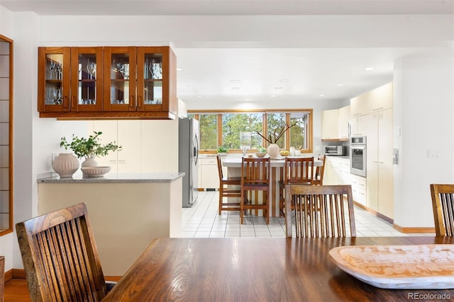 dining room featuring recessed lighting, a toaster, baseboards, and light tile patterned floors