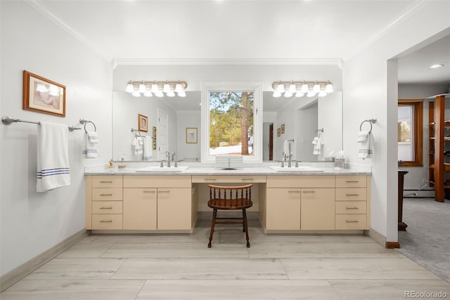 bathroom with a baseboard heating unit, baseboards, crown molding, and vanity