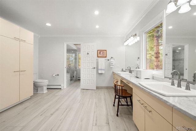 full bath with a baseboard radiator, a sink, toilet, and crown molding